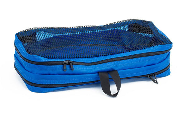 An empty and zipped closed Island (blue) Aether Small Laundry Aeronaut 45 Packing Cube mesh side up.